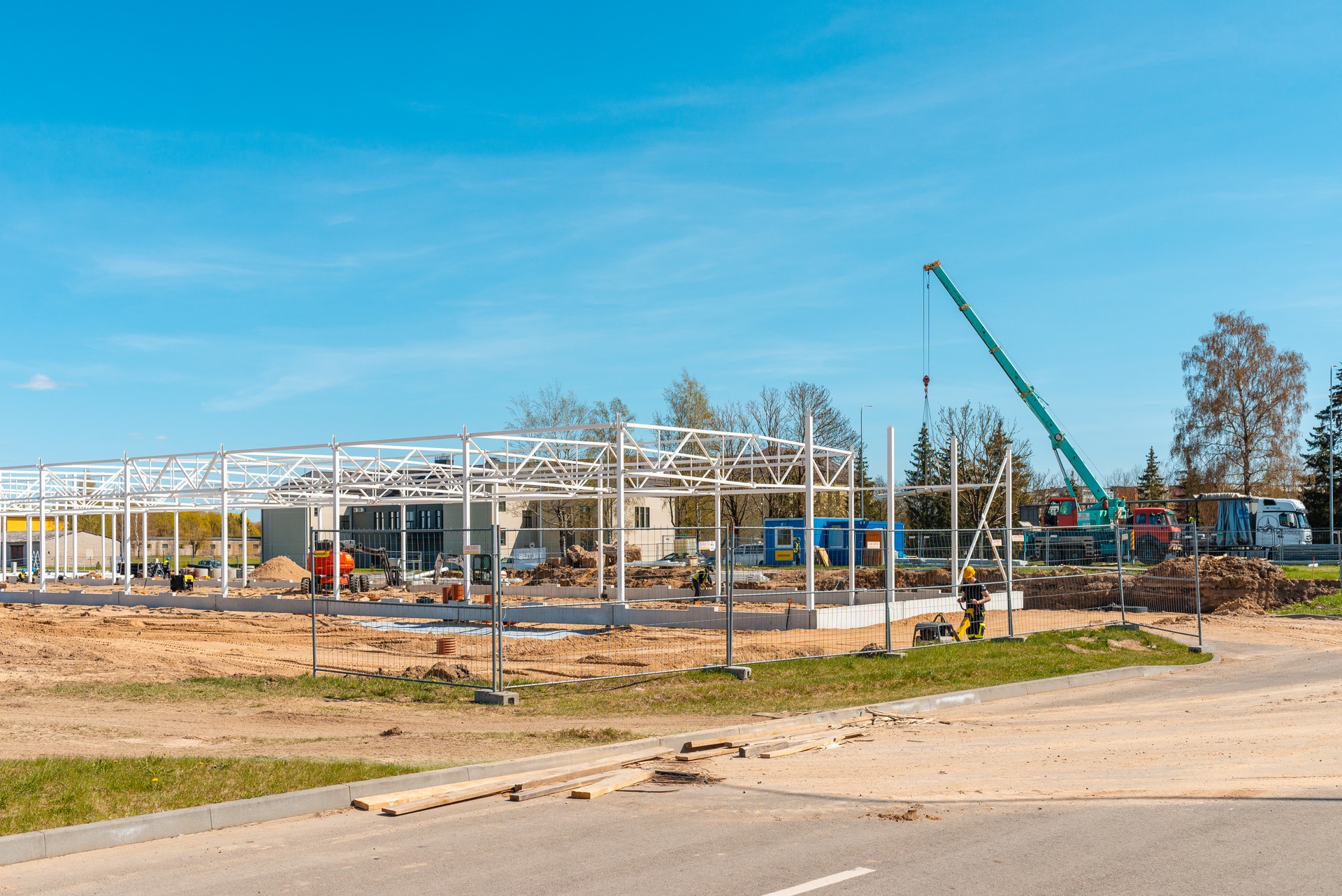 Urban area with machinery, people are working on construction site.Telsiai,Lithuania 05-10-2022.